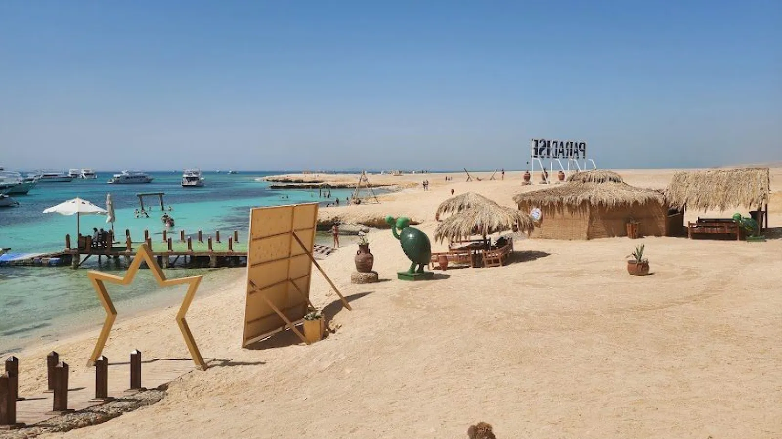 Sandy beach, jetty and shallow turquoise lagoon on Paradise Island near Hurghada