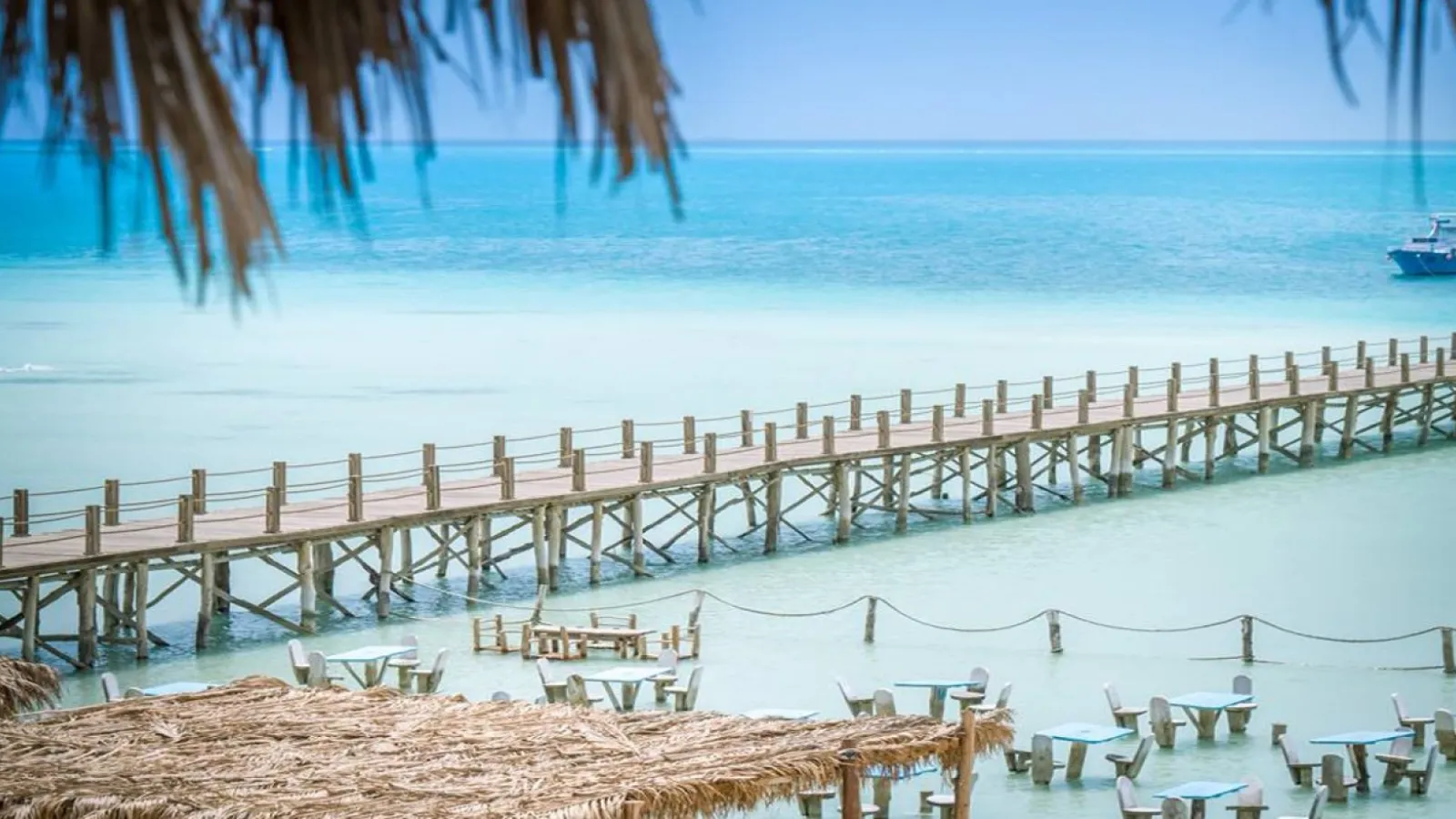 Long wooden pier stretching over the shallow turquoise water of Orange Bay, Hurghada