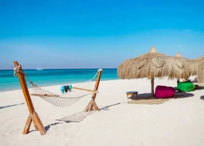 Hammock and thatched umbrellas on the white sand of Hula Hula Island, Hurghada