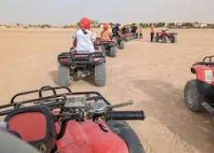 Group of riders on red quad bikes lined up in the desert near Hurghada