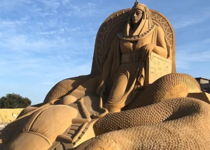 Sand sculpture of a pharaoh queen on a throne at Sand City, Hurghada