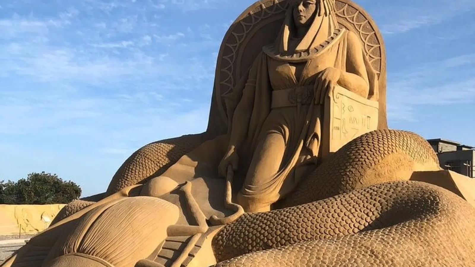 Sand sculpture of a pharaoh queen on a throne at Sand City, Hurghada