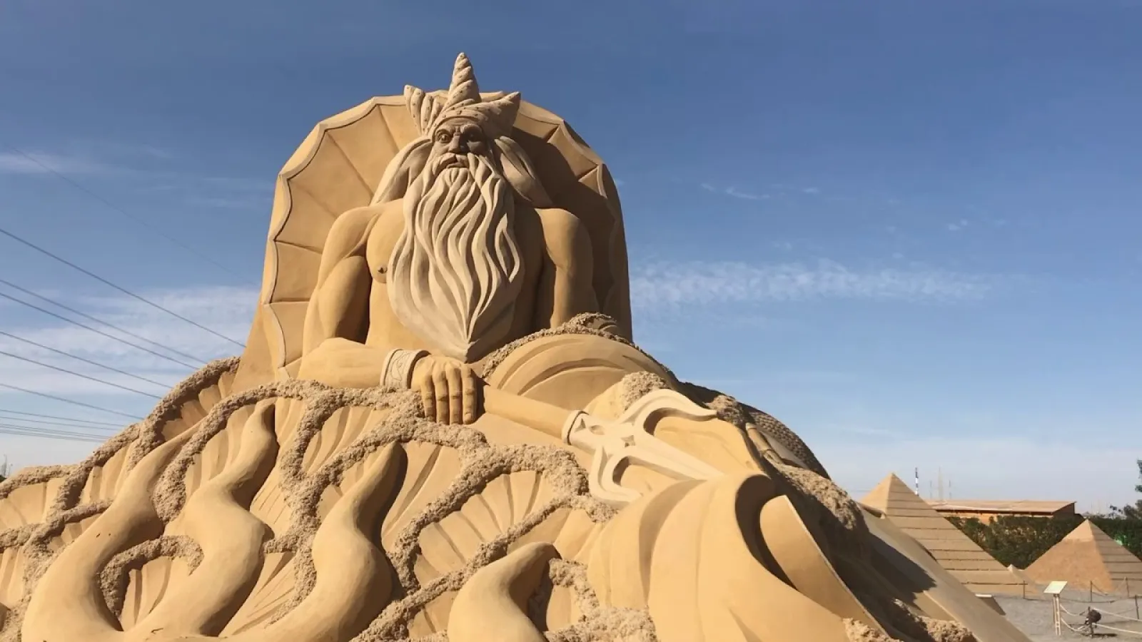 Sand sculpture of Poseidon holding his trident at Sand City, Hurghada
