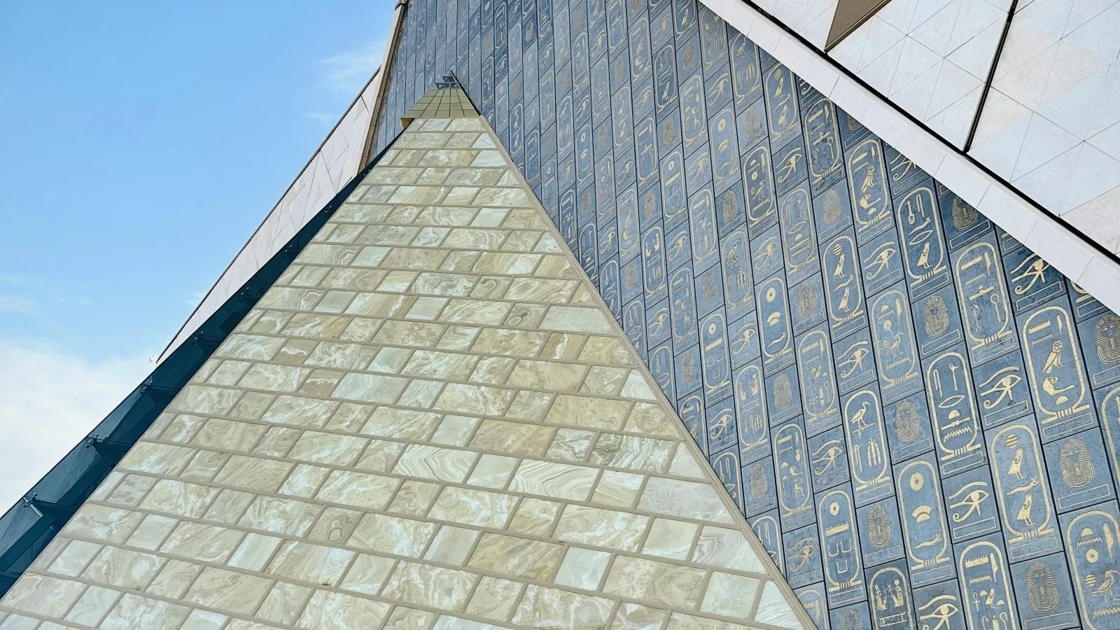 Hieroglyph-carved triangular façade of the Grand Egyptian Museum in Giza